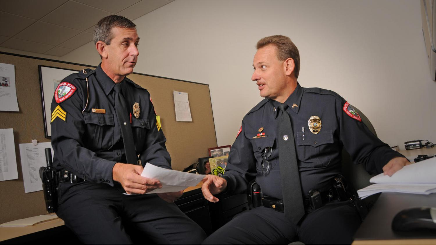 two police officer talking in office
