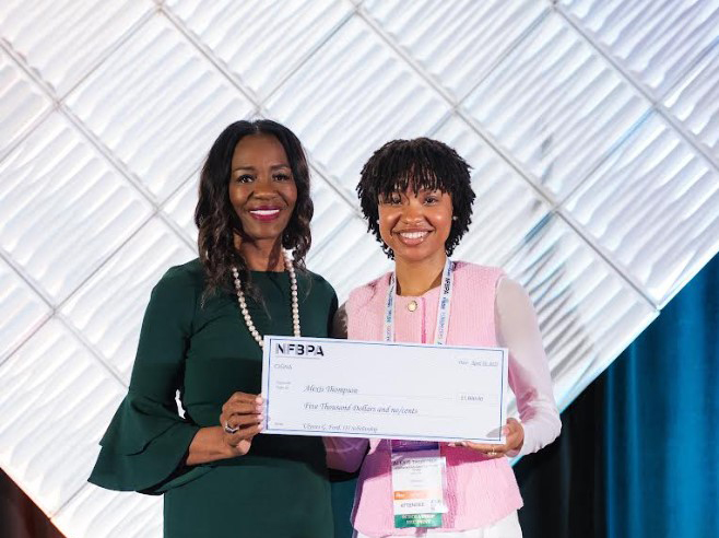Alexis Thompson holds her award scholarship