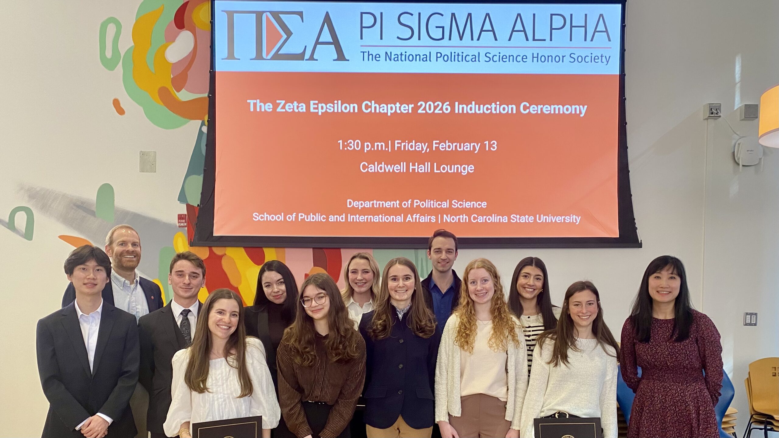 Members of Pi Sigma Alpha's Zeta Epsilon Chapter pose with faculty advisors following their induction ceremony.